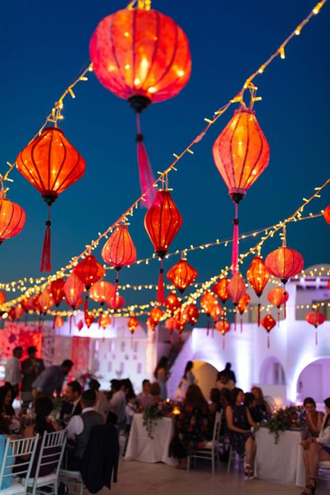 Authentic Chinese character honoring our couple’s tradition with red lanterns hanging over the wedding dinner tables setup |Santorini Wedding Planner & Designer: @mitheoevents Photo: @vangelisphotography Venue: @rocabellasan | #mitheoevents #weddingplannersantorini #destinationweddingsantorini #santoriniwedding #chinesewedding #luxurywedding #seasidewedding #chinoiserie #weddingstyling #weddingdecor #bluewhitewedding #redlanterns #chineselanterns #ambientlighting #weddinglighting Chinese Lanterns Wedding, Dinner Tablescape, Asian Wedding Decor, Chinoiserie Wedding, Chinese Wedding Decor, Lanterns Hanging, Red Lanterns, Lantern Decor Wedding, Traditional Chinese Wedding