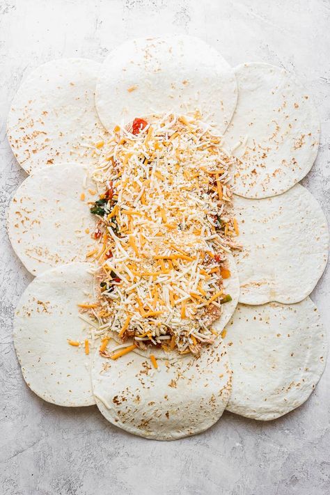 Put all the filling for your sheet pan quesadillas on top of your tortillas and fold all the sides in before baking. Baked Sheet Pan Quesadilla, Tortilla Sheet Pan Recipe, Baked Wraps Tortilla, Baked Tortillas In Oven, Baked Tacos Flour Tortillas, Tortilla Shells What To Make With, Fold Over Tortilla Bake, Recipes Using Flour Tortillas, Shredded Salsa Chicken