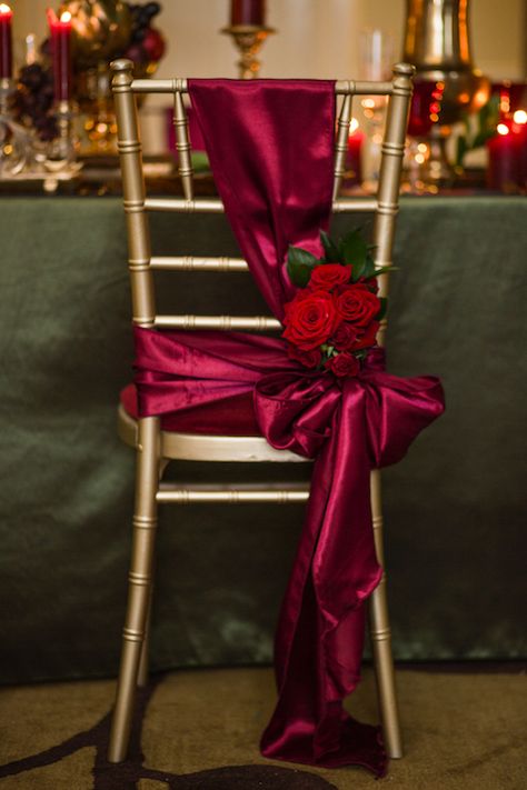 Wedding chair decor, Bordeaux satin adorned with roses by Debonair Venue Styling Red Wedding Chairs, Floral Arches Wedding, Royalty Wedding Theme, Dekor Pelaminan, Wedding Chair Decor, Arches Wedding, Jewel Tone Color Palette, Floral Arches, Wedding Ceremony Decor