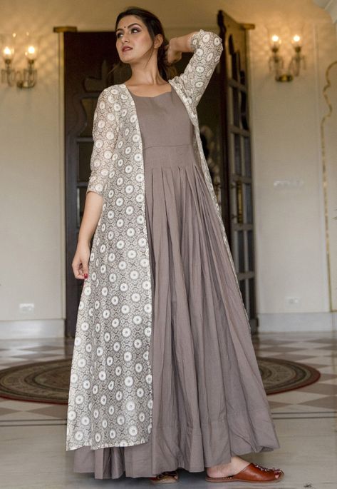 Muslin Cotton Gown in Grey This Readymade Attire with Faux Crepe Lining is Enhanced with Floral Print. Crafted in Round Neck and Quarter Sleeves Available with an Art Chanderi Silk Long Jacket in Off White The Gown and Jacket Lengths are 58 and 56 inches respectively Do note: Accessories shown in the image are for presentation purpose only and length may vary upto 2 inches.(Slight variation in actual color vs. image is possible). Gown With Jacket, Stylish Gown, Long Frock Designs, Cotton Gowns, Gaun Fashion, Casual Fridays, Cotton Kurti Designs, Printed Gowns, Beige Jacket