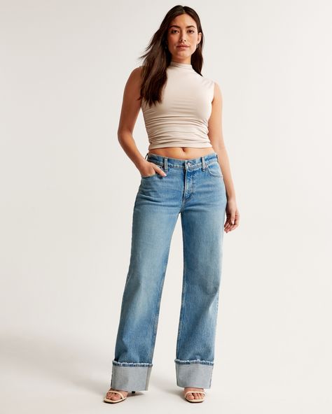 Our Curve Love low rise baggy jeans in a medium wash with a cuffed hem. This fit features a 8.5” low rise, is slightly relaxed at waist and hips, and eases at the thigh into a baggy, full-length leg shape. We recommend buying your true size for a baggier fit. Size down for a closer fit. The viral fit that eliminates waist gap: Curve Love features additional room through the hip and thigh for curve-hugging comfort. This jean is made from our vintage stretch fabric which features both an authentic Abercrombie And Fitch Outfit, Low Rise Baggy Jeans, Baggy Jean, Abercrombie Jeans, Cuffed Jeans, Love Jeans, Jeans For Short Women, Baggy Jeans, Baggy Fits