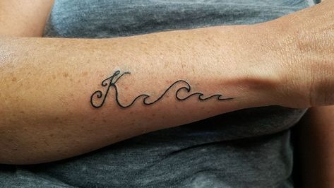 My latest tattoo. Last name initial with beach waves because it’s my favorite place Wave Tattoo With Words, Wave With Name Tattoo, Wave With Initials Tattoo, Wave With Words Tattoo, What Does A Wave Tattoo Symbolize, Oma Tattoo, Letter K Tattoo, Est. Tattoo, Moms Tattoo