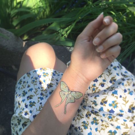 Realistic Luna moth tattoo, wrist tattoo Luna Moth Forearm Tattoo, Realistic Luna Moth Tattoo, Moth Tattoo On Wrist, Lunar Moth Tattoo Color, Simple Lunar Moth Tattoo, Luna Moth Wrist Tattoo, Green Luna Moth Tattoo, Small Moth Tattoo Simple, Moth Tattoo Wrist