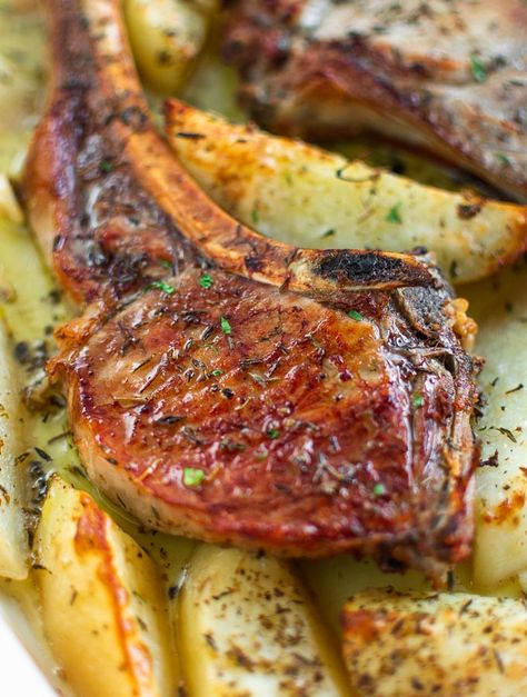 A quick, easy way to make tender & juicy Baked Pork Chops. With soft, mellow potatoes on the sides, roasted garlic bits and flavored with marjoram, thyme and lemon! Greek Pork Chops, Greek Pork, Baked Pork Chops Oven, Tender Pork Chops, Pork Chops And Potatoes, Cooking Pork Chops, Roasted Chicken And Potatoes, Juicy Pork Chops, Slow Cooked Lamb