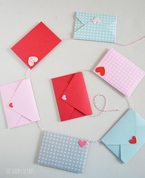 This Mini Envelope Valentine Banner is the perfect addition to your Valentine decor. The mini envelopes are so cute and the puffy heart stickers make the perfect "stamps." Create your own with the tutorial on the blog. Mini Envelopes Ideas, Diy Valentine Envelopes, Valentines Day Envelopes Diy, Envelope Garland, Diy Mini Envelopes, Mini Envelopes Diy, Envelope With Heart, Valentine Dance, Valentine Minis