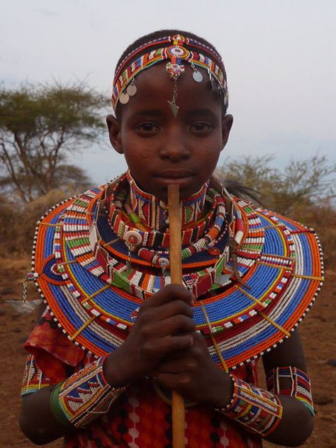 Masai Mara, Kenya. In every tribe, the male Masai pass through three main life stages- boyhood, warrior-hood and elder-hood. Masai Tribe Art, Kenya Clothing, Masai Art, Masai Tribe, Maasai People, Masai Mara Kenya, Masai Clothing, Blue Yellow Orange, Wedding Necklaces