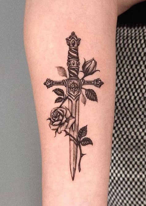 69 Striking Dagger Tattoos With Meaning Daggar Tattoo, Knife And Rose Tattoo, Rose And Dagger Tattoo, Cross Tattoo On Hand, Rose Tattoo With Name, Rose And Dagger, Rose Tattoo Meaning, Rose Hand Tattoo, Rose Tattoos For Men