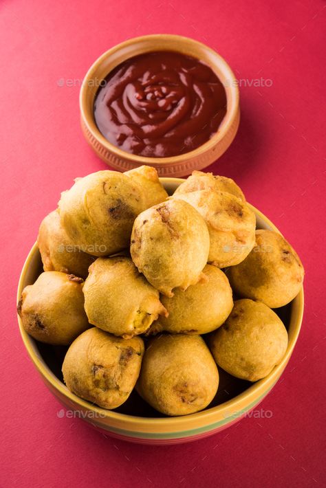 Batata Vada or Aloo Bonda by stockimagefactory. Batata Vada or Aloo Bonda is an Indian tea-time snack served with green chillies and tomato ketchup #Sponsored #stockimagefactory, #Indian, #tea, #Bonda Batata Vada, Textures Art, Indian Tea, Tea Time Snacks, Tomato Ketchup, Breakfast Items, Chutney, Ketchup, Street Food