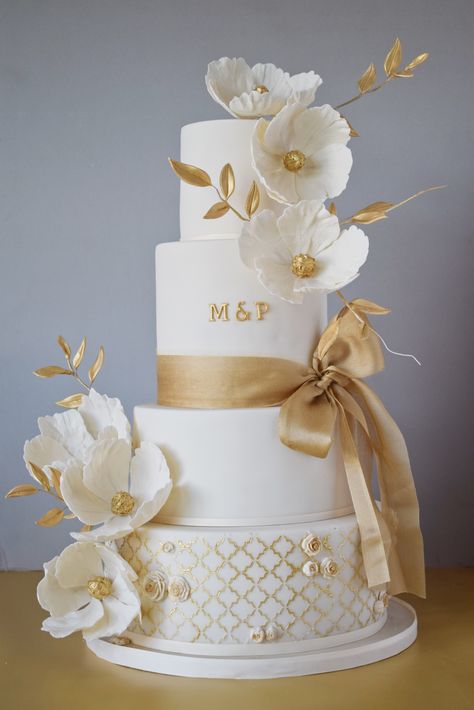 old and ivory wedding cake with fantasy florals, golden foliage and statement side bow at stunning venue @addingtonpalace . . . . . #weddingcake #goldwedding #goldleaves #londonwedding #londonweddingcake #kentweddingcake #surreyweddingcake #wedding #weddingcakes #cake #goldweddingcake #elegantweddingcake #realweddings 3w Golden Wedding Cake, Wedding Exhibition, Ivory Wedding Cake, Reception Cake, Winning London, Fondant Wedding Cakes, Kent Wedding, Cake Accessories, Cake Trends