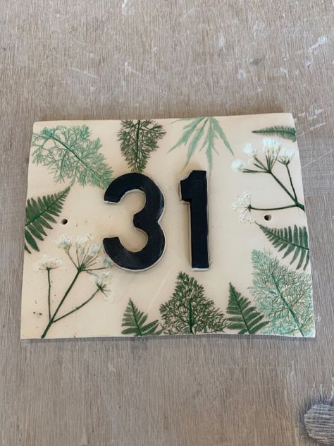 Handmade house number tile with rolled plants. Not yet had a final firing. Ceramic House Name Plaques, Ceramic Numbers House, House Number Ceramic, Clay House Numbers, Pottery House Numbers, Stairs And Hallway Ideas, Tile House Numbers, House Name Signs, Handmade House