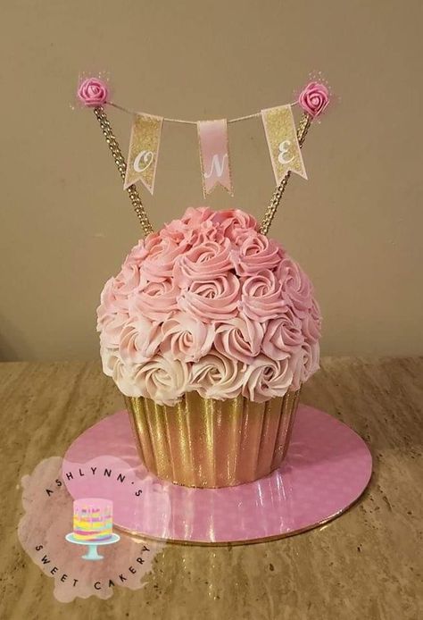 Pink and gold giant cupcake smash cake Pink And Gold Smash Cake 1st Birthdays, Cupcake Smash Cake Girl, 1 Year Birthday Cupcakes, Big Cupcake Cake 1st Birthday, Cupcake Cake Smash, Pink And Gold One Year Birthday, Pink Smash Cake Girl, Giant Cupcake Smash Cake, Pink And Gold 1st Birthday Cake