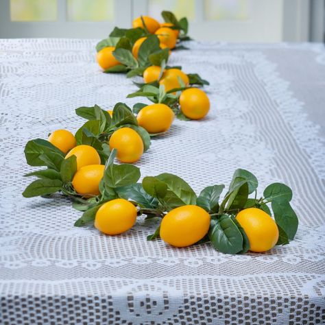 Trendy and whimsical, this table decorating kit is the perfect complement to a lemonade party theme. An ideal choice for lemon bridal showers, it's also great for garden parties, birthday parties, or any other event where that sour-sweet beverage is the order of the day. Lovely, lacy, and lemony-yellow, this table décor kit will make your vintage event picture-perfect.Includes:o 1 Plastic Artificial Lemon Garland (6 ft.)o 1 Polyester White Lace Tablecloth (90" x 60" Imported.)o Assortments are subject to change at any time and may vary from picture shown. Substituted items will be similar in nature. Lemon Themed Engagement Party, Lemon Bid Day Theme, Italy Themed Bridal Shower Ideas, Italian Table Decorations, Lemonade Party Theme, Lemon Garland, Greece Party, Greek Theme, Italian Dinner Party