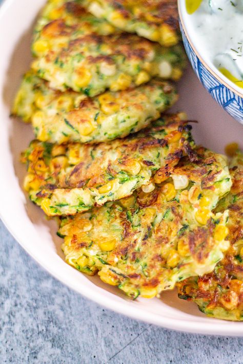 Zucchini and Corn Fritters are crispy little cakes of corn and shredded zucchini seasoned with Pecorino Romano, garlic, and lemon juice. Serve them as an appetizer or side dish! Zucchini And Corn Fritters, Easy Zucchini Fritters, Corn Fritter, Zucchini Pizza Crust, Life Themes, Corn And Zucchini, Corn Fritter Recipes, Light Cooking, Pecorino Romano