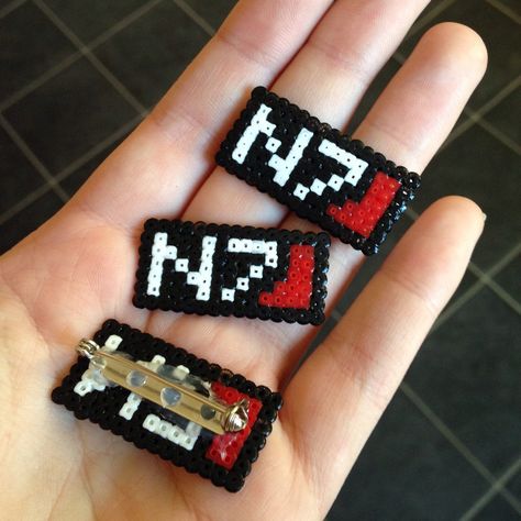 Just made a brand new batch of our N7 badges, in honour of one of the best video game trilogies ever: Mass Effect. Looking forward to Andromeda! Mass Effect Perler Beads, Peg Crafts, Wedding Ides, Cross Stitch Boards, Iron Beads, Stitch Ideas, Beaded Cross Stitch, Pixel Pattern, Bead Ideas