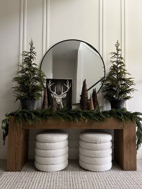 christmas decor on entry way table with two white ottomans and a round mirror. Entryway Christmas Decor Entry Tables, Norfolk Pine Tree, Christmas Entryway Decor, Entry Way Decor, Table Tree, Christmas Entry, Entryway Decor Ideas, Entry Table Decor, Christmas Entryway