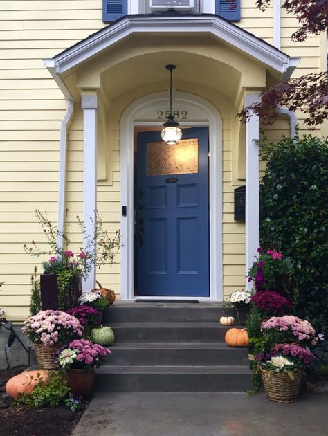 Yellow House Navy Door, Front Door With Yellow House, Blue Shutters Yellow House, Yellow House With Blue Door, Yellow And Blue House Exterior, Yellow House Color Scheme Exterior, Front Door Yellow House, Yellow House With Blue Shutters, Yellow House Blue Door