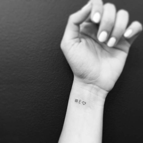 IIII.E. and heart tattooed on the wrist. Wrist Tattoos Heart, E Initial Tattoo, Latin Script, Minimalist Lettering, Typewriter Letters, Font Letters, Initial Tattoo, E Tattoo, Little Tattoos