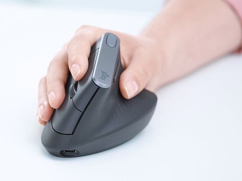 The MX Vertical: Logitech's New Ergonomic Mouse Form Factor Uses a "Handshake" Position - Core77 Logitech Mouse, Vertical Angles, Creative Office Space, Mouse Computer, Muscle Strain, Rise Above, Improve Posture, Desk Set, Wireless Mouse