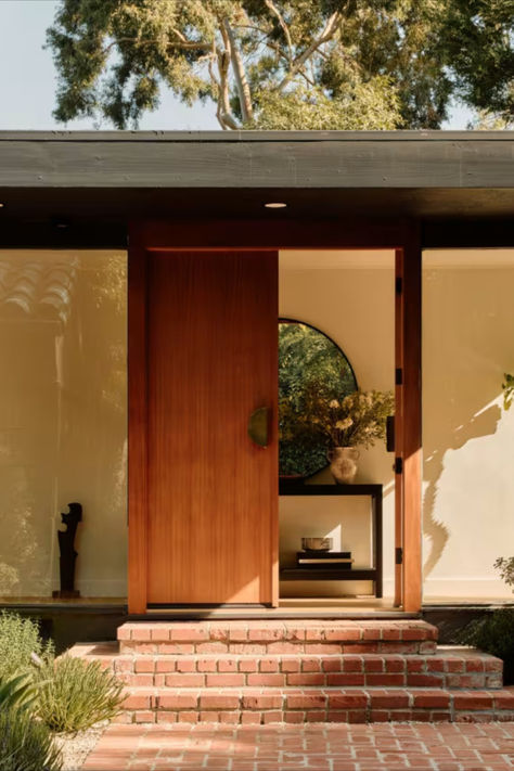 Modern entryway with a sleek wooden door, large windows, and elegant landscaping. Entryway Doors Exterior, Scandinavian Front Door, Wooden Exterior Doors, Entryway Interior Design, Modern Entryway Design, Elegant Landscaping, Entryway Design Ideas, Entryway Design, Entry Decor