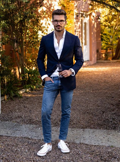 A seamless blend of formal and casual with a sharp navy blazer and white shirt paired with blue jeans and crisp white sneakers, perfect for any occasion that calls for stylish versatility. Jean And Sport Coat Men, Navy Blue Blazer Outfit Mens Casual, Jeans And Blazer Outfit Men, Navy Blue Blazer Outfit Mens, Blazer And White Shirt, Blazer White Dress, Suit With Jeans, Navy Blue Blazer Outfit, Navy Blazer Outfits