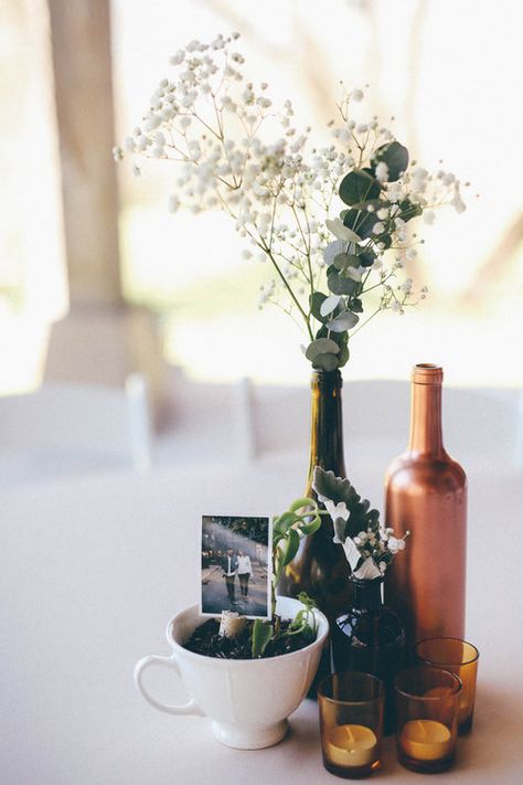 Vintage Bottle Centerpieces, Wine Bottle Centerpieces Eucalyptus, Wine Bottle With Flowers Centerpieces, Wine Bottle Flower Arrangements Wedding, Wine Bottle Table Decor, Picture Centerpiece Ideas, Wine Bottle Flower Arrangements, Wine Bottle Centerpieces For Wedding, Bottle Centrepiece