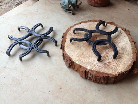 These are our center pieces! Cedar rounds, trivets made from horseshoes, mason jars for vases, and pinecones scattered around Horseshoe Trivet, Blacksmith Projects, Horseshoe Art, Shoe Art, Trivets, Pine Cones, Blacksmithing, Metal Art, Metal Working