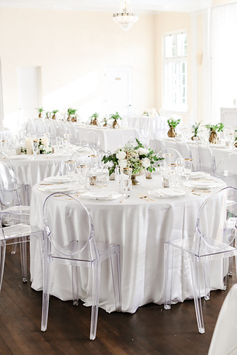 Classic Neutral Wedding Reception Decor, Round Table with White Linen, Low Gold Vase with Ivory and Greenery Floral Centerpiece, Clear Ghost Acrylic Chairs | Tampa Bay Wedding Photographer Lifelong Photography Studio | Wedding Rentals Kate Ryan Event Rentals | Historic Wedding Venue The Orlo Ghost Chairs Wedding Reception, White Drapes Wedding, Neutral Wedding Reception, Classic Neutral Wedding, Ghost Chair Wedding, Burgundy And Grey Wedding, Champagne Decor, Wedding Reception Chairs, Round Wedding Tables