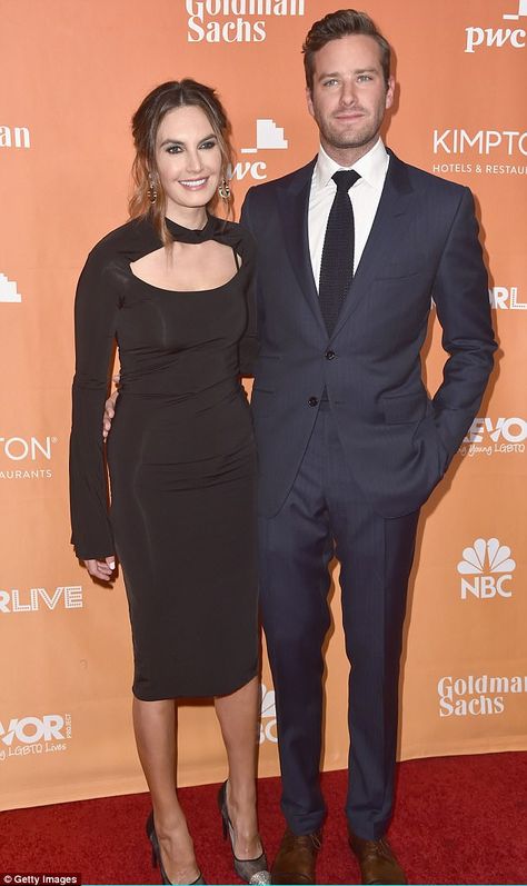 Stunning couple: Armie Hammer, 31, was dapper in a navy two-piece suit while wife Elizabeth Chambers looked gorgeous in a clingy long-sleeved black dress with keyhole bodice Black Dress Blue Suit Couple, Navy Suit And Black Dress Couple, Black Dress Couple, Hair Framing, Elizabeth Chambers, Wet Look Dress, Armie Hammer, Navy Blue Suit, Navy Suit