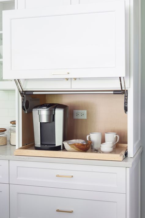 This coffee area with pull-out shelf is perfect kitchen storage idea. Incorporating an appliance garage for your kitchen appliances is a great way to keep them accessible but still out of site. 
#kitchenappliancegarage #kitchenstorageideas #coffeebar #kitchendesign #kitchenstoragecabinet #pulloutshelf Coffee Station Kitchen, Kitchen Appliance Storage, Appliance Garage, Hidden Kitchen, Coffee Bars In Kitchen, Appliances Storage, Home Coffee Bar, Studio Kitchen, Transitional Kitchen