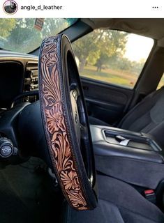 Handmade leather steering wheel cover Custom Leather Seats Truck, Western Leather Steering Wheel Cover, Western Steering Wheel Cover, Western Seat Covers, Truck Interior Ideas, Western Car Accessories, Truck Interior Accessories, Western Car, Leather Steering Wheel Cover