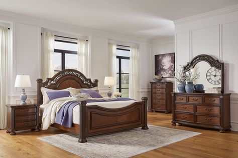 Grey bedroom with brown furniture