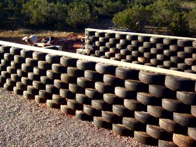 LOTS of questions / answers about earthship building. Tire Wall, Tire Retaining Wall Ideas, Tire Fence, Tire Wall Fence, Tyre Walls, Retaining Wall Using Old Tires, Tire Art Installation, Earthship Tire Wall, White Wall Tires Cars