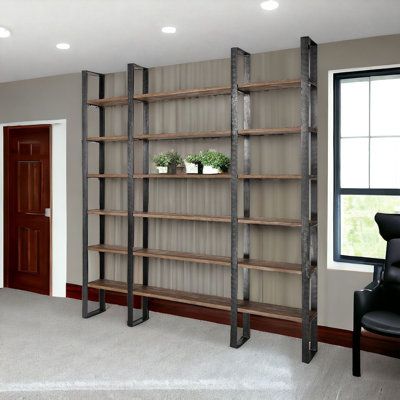 Featuring six shelves made from sawn grey Indian hardwood, the Eccles 90" bookcase is a simple, yet elegant shelving unit with plenty of storage and display space. The shelves are held in place and stabilized by four, sturdy metal beams and hammered finish brackets that also add to the visuals of the piece. With soft wooden tones and metallic black accents, the Bookcase looks great in spaces based on the Industrial design style. | 17 Stories Eccles 90" Brown Solid Wood and Iron Six Tier Bookcase Store Shelves Design, Industrial Design Style, Metal Beam, Pharmacy Design, Spa Interior, Frame Shelf, Wall Bookshelves, Industrial Shelving, Home Office Setup