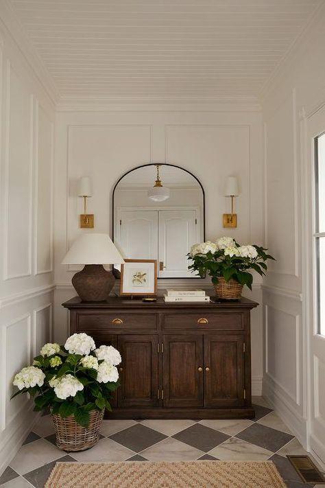 Beautifully styled vestibule boasts a stunning brown wooden cabinet placed on black and white marble harlequin floor tiles beneath brass sconces flanking a black arch mirror. House Inspo, Dream Home Design, Decor Bedroom, First Home, House Inspiration, Entryway Decor, House Decor, Vintage Decor, Bedroom Interior