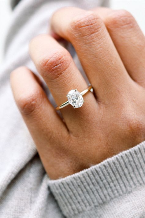 A stunning way to showcase an oval diamond or elongated fancy shape, featuring petite prongs and a support bar for maximum light exposure. Customize your solitaire engagement ring with band widths from 1.8-3.5mm, in a rounded comfort fit or knife edge style. Shown with a 1.5ct oval lab diamond in 18k yellow gold. https://www.adadiamonds.com?utm_source=pin&utm_medium=social&utm_campaign=1.5ct-oval &utm_content= Plain Gold Oval Engagement Ring, Classic Oval Solitaire Engagement Ring, Oval Plain Band Engagement Ring, Gold Band With Silver Prongs, Oval Vs Circle Engagement Ring, Plain Gold Diamond Ring, Four Prong Oval Engagement Ring, Oval Engagement Ring 1.5, Oval Engagement Ring Gold Band Silver Prongs