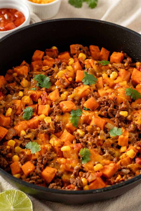 Introducing the Mexican Ground Beef and Potato Skillet – a quick weeknight dinner that's ready in just 30 minutes! It features taco-seasoned ground beef, sweet potatoes, onions, and tomatoes to bring you all the delicious Mexican flavors. Sweet Potato Mexican Skillet, Sweet Potato Taco Skillet, Sweet Potato Ground Beef Bowl, Ground Beef Sweet Potato Recipes, Mexican Beef Skillet, Sweet Potato Caserole, Sweet Potato Ground Beef, Beef And Potato Skillet, Taco Sweet Potato