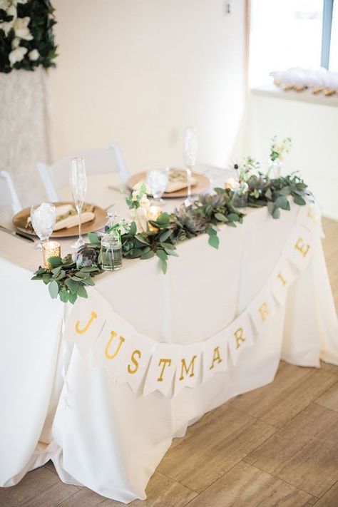 Simple Wedding Table For Bride And Groom, Sweetheart Table With Garland, Garland On Sweetheart Table, Simple Bride Groom Table, Bride And Groom Table Candles, Small Bride And Groom Table, Small Head Table Wedding, Sweetheart Table Garland With Flowers, Sweetheart Table Setup