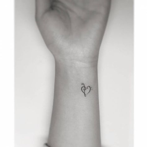 Bass and Treble clef heart. Treble Bass Clef Heart Tattoo, Treble Clef Bass Clef Tattoo, Mini Tattoos Music, Heart Tattoo Fine Line, Treble Tattoo, Bass Clef Tattoo, Music Wrist Tattoos, Bass And Treble Clef, Music Heart Tattoo