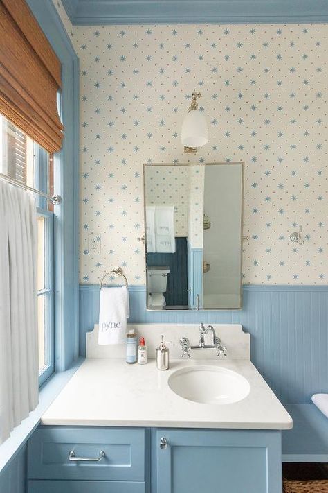 Charming white and blue boys' bathroom features a rectangular pivot mirror mounted against a wall covered in Sister Parish Serendipity wallpaper lined with a blue beadboard backsplash. Blue Beadboard, Light Blue Paint Colors, Sister Parish, Light Blue Paints, Blue Paint Colors, Blue Cabinets, Boys Bathroom, Rooms Reveal, Blue Bathroom