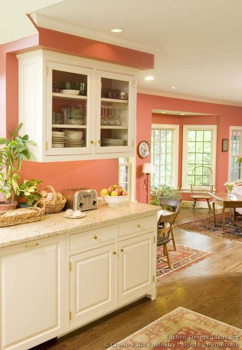 peach kitchen with creamy white cabinets, pantone blooming dahlia Victorian Kitchen Cabinets, Traditional White Kitchen Cabinets, Coral Kitchen, Victorian Kitchens, White Kitchen Cupboards, White Kitchen Traditional, Peach Kitchen, Colorful Kitchen Decor, Victorian Kitchen