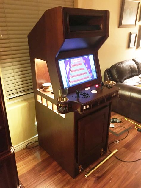 Built this arcade cabinet based on the shape of the tapper video game console from the 80's. Added a few items to make it a bit more useful. Whiskey shelf on the top, wine racks below that, and beer fridge behind bottom door. Considering making this a build to order product. Whisky Regal, Whiskey Shelf, Retropie Arcade, Arcade Cabinet Plans, Diy Arcade Cabinet, Cabinet Fridge, Scratched Wood, Vintage Arcade, Arcade Room