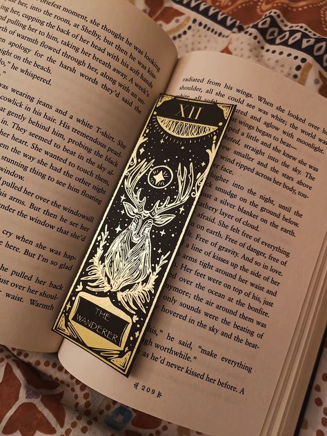 ✨ The Wanderer - Handcrafted Gold Foil Bookmark with Deer, Stars & Foliage | Holographic or Matte Finish ✨ Add a touch of elegance to your reading with The Wanderer, a handcrafted gold foil bookmark designed on premium black cardstock. Featuring a stunning deer, foliage , Roman numerals , and stars , this bookmark is perfect for book lovers 📚 and collectors alike.  Made with premium smooth 300gsm black cardstock and gold foil Size: 16cm x 5.5cm Available in holographic laminate 🌈, star hologra Book Bookmark Design, Foil Bookmark, Cute Stationary School Supplies, The Wanderer, Stationary School, Cute Stationary, Foil Art, Blind Dates, Personalized Accessories