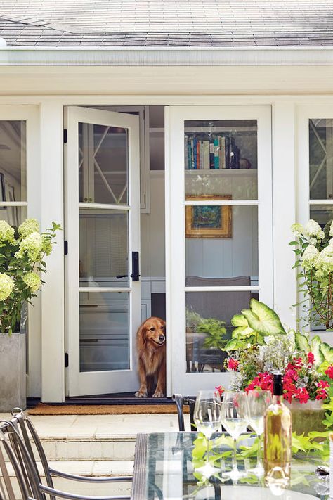 The Patio Doors Open Up the Exterior - A Dramatic Ranch House Renovation - Southernliving. "Ranches tend to have 8-foot ceilings and not a lot of natural light, making them feel cramped," Evans notes. Three new sets of 7-foot-tall French doors significantly brighten up the interior rooms surrounding the patio and allow people to move indoors and outdoors much more easily. Ranch House Renovation, Pintu Interior, Architecture Renovation, Front Door Makeover, French Doors Exterior, French Doors Patio, Front Steps, Ranch Style Home, French Doors Interior