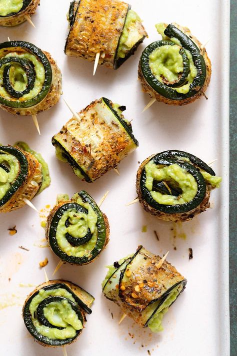 These Zucchini Rolls are made with spicy roasted zucchini slices filled with creamy guacamole. You can serve these as an appetizer or a side. If you don't like guacamole, you can fill them with creamy goat cheese or any other spread or dip you enjoy! The zucchini can be substituted with thinly sliced cucumber too for a no-bake healthy snack. Zucchini Roll Up Appetizer, Zucchini Snacks, Healthy Buffet, Baked Cucumber, Zucchini Appetizers, Filled Zucchini, Zucchini Appetizer Recipes, Zucchini Roll Ups, Cucumber Avocado Rolls