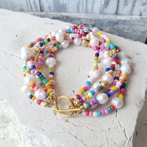 "I love how this one turned out. Multi strands of colorful seed beads and white freshwater pearls make up this colorful and happy Bracelet. Choose from 2-6 strands. Choose from, 7\", 7.5\" or 8\". All six strands are secured with a gold toggle closure. See the matching NECKLACE as seen in photo 5 here: All my jewelry comes gift boxed and ready for gift giving, whether it is a gift for you or someone special.  Visit my jewelry shop at:    http://www.etsy.com/shop/JensBeadBox?ref=seller_info  Than Bead Color Combinations, Bead Pearl Bracelet, Happy Bracelet, Jewelry Colorful, Color Bracelet, Toggle Bracelet, Funky Jewelry, Jewelry Lookbook, Colorful Jewelry