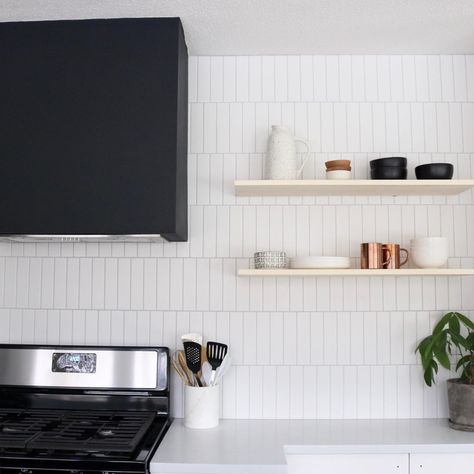 Vertical offset subway tile with black hood vent and floating shelves Vertical Offset Subway Tile, Offset Subway Tile, Kitchen Vents, Subway Tile Kitchen Backsplash, Kitchen Splashback Tiles, Tile Kitchen Backsplash, Scandinavian Kitchen Design, Subway Tile Backsplash Kitchen, Exhaust Hood