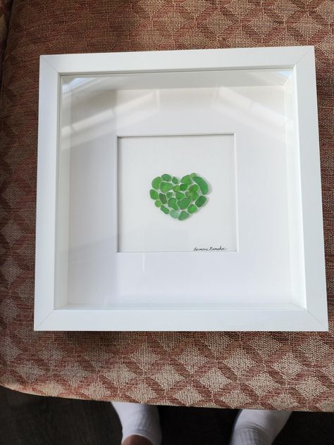 Framed Seaglass in a Heart Shape. This surf tumbled green seaglass from Hawaii. Seaglass Canvas Art, Seaglass Collection Display, Seaglass Art Ideas, Sea Glass Art Ideas, Seaglass Picture, Seaglass Ideas, Beach Glass Projects, Seaglass Crafts, Beach Themed Wall Art