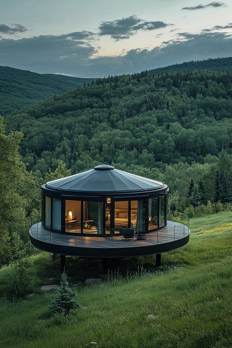 Prefab glass nad matte black steel round yurt on a large platform in a green valley. Check out all of these innovative and stylish prefab homes that bring modern designs to life. This is the future of cheap and sustainable living! Modern Glamping House, Yurt Home Ideas, Permanent Yurt Home, Circular House Design, Luxury Homesteading, Yurt Platform, Large Tiny House, Modern Yurt, Circular Homes