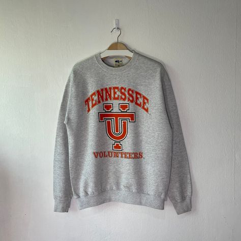 Vintage 90s University of Tennessee Volunteers Crewneck Sweatshirt (L) Condition : Used vintage Good conditions Details : stains (Look at the picture) 📍Please Let me know if you have any questions or More Photo Detail Brand : My Town Originals Made in : USA 🇺🇸 📍Measurement Size On Tag : L, (fit like M) Pit to pit : 22 inches Length : 27 inches 📍Material : Cotton Polyester Color : Light Gray ⛔️ Please keep in mind that our items are vintage so they may show some signs of wear and tear ⚠️ Ple Vintage Tennessee Vols, University Of Tennessee Sweatshirt, Tennessee Vols Apparel, Volunteer Shirt, Vintage Tennessee Vols Shirt, Tennessee Vols Hoodie, College Shirts, University Sweatshirts, Tennessee Volunteers