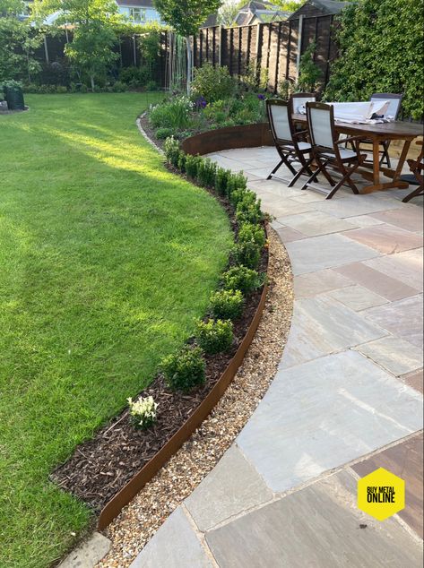 Simple but stunning. Corten sheets with a gradual incline to separate the patio area from the lawn Lawn Separation Ideas, Patio With Gravel Border, Patio Lower Than Lawn, Paving Edging Ideas, Simple Garden Borders, Raised Landscape Border Ideas, Modern Garden Edging, Border Around Patio, Patio Edging Ideas